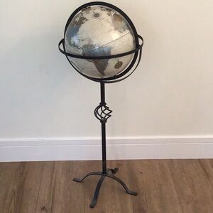 Vintage-style terrestrial globe on a forged iron stand, produced by Replogle.